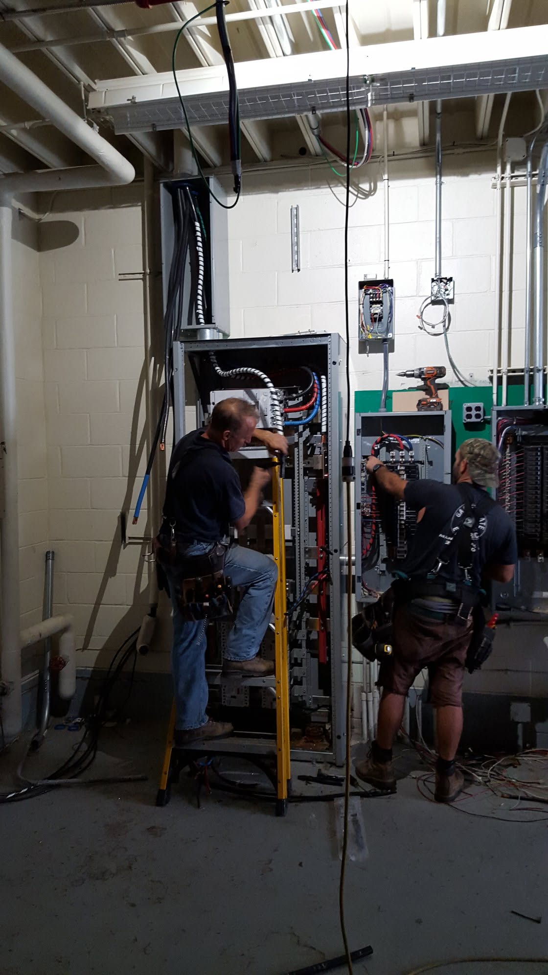 Garden State electricians installing a commercial electrical distribution panel